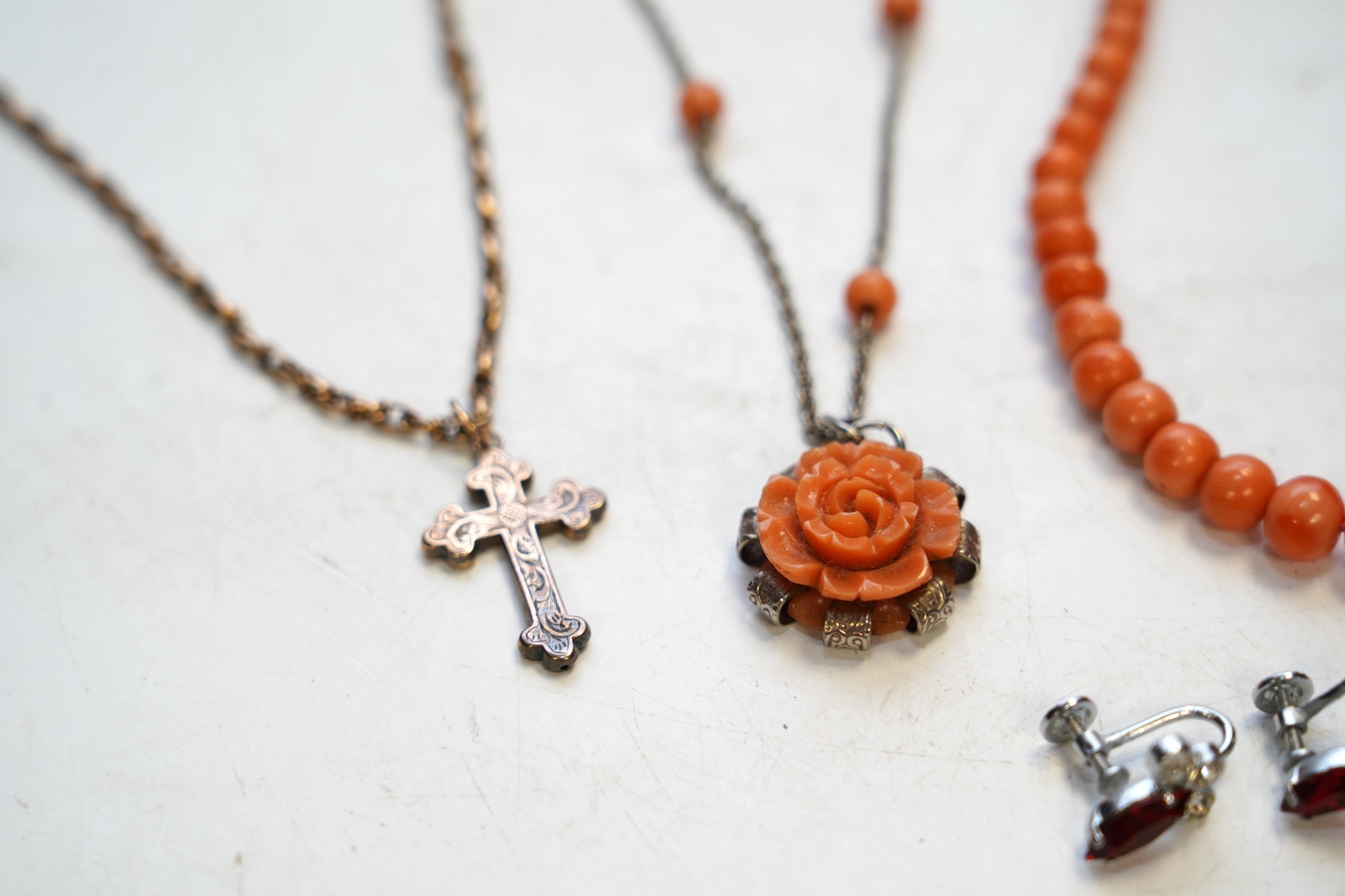 A Victorian yellow metal crucifix on a yellow metal chain, a coral necklace and other assorted jewellery. Condition - fair to poor
